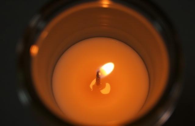 Image of a lit scented candle.